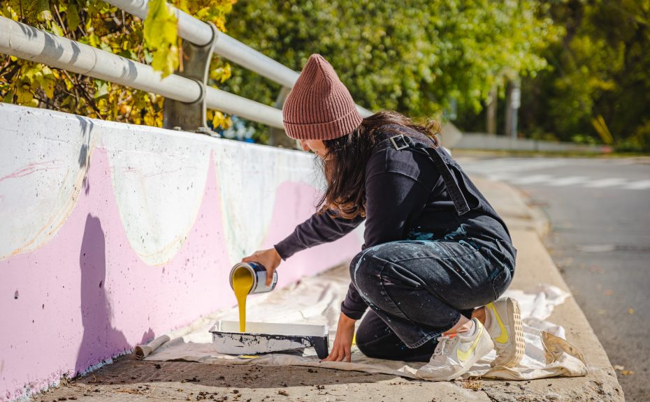 Artist Vanessa Spizzirri working on Dog Meets City mural
