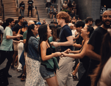 Couples dancing Bachata at a lively event at The Well Toronto.
