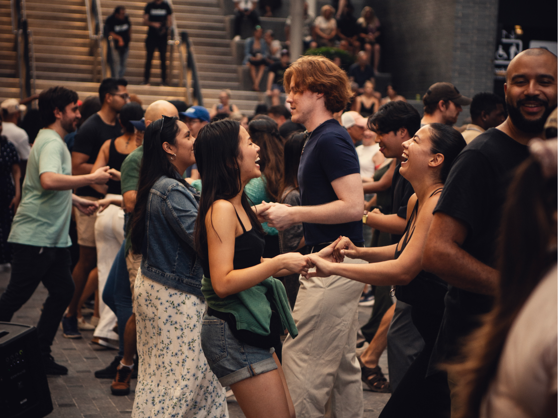 Couples dancing Bachata at a lively event at The Well Toronto.